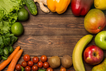 Fruits and vegetables on rustic wooden backround with space for text. Healthy eating, dieting, slimming and weigh loss concept. Vegetarian food
