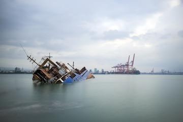 Fototapeta na wymiar Sinking ship. Industrial sea port of Mersin. Turkey