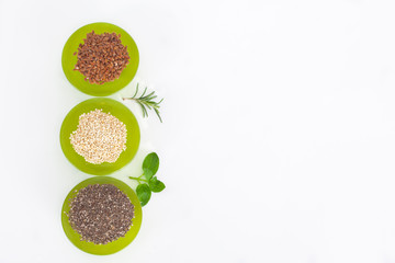 Healthy grains in green bowls. Chia, quinoa and flax seed. Top view.