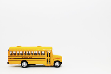 Yellow school bus kids toy on white background