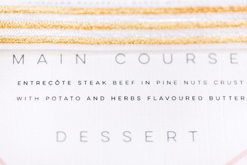 Wedding menu with gold ribbon