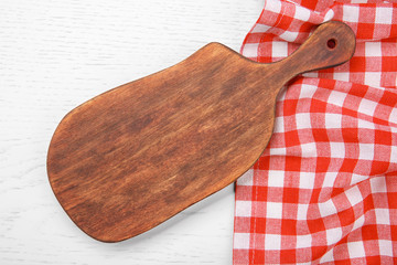 Red napkin and cutting board on wooden table