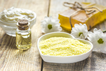 natural essential aroma oil with camomile on wooden table background