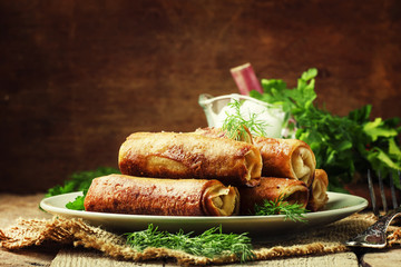 Pancakes with meat, rustic style, wooden background, selective focus