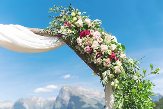 flowers wedding arch with alps backdrop