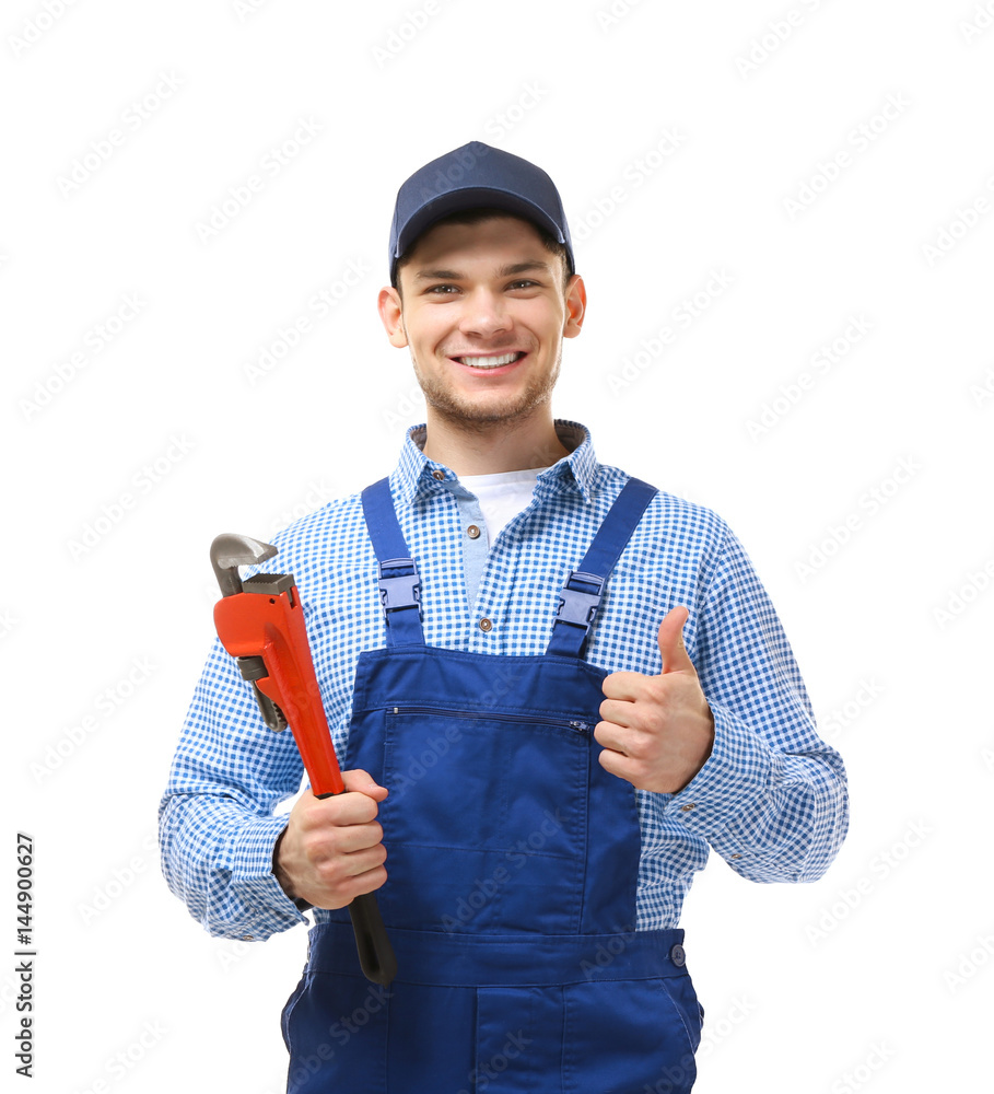 Wall mural young plumber holding pipe wrench isolated on white