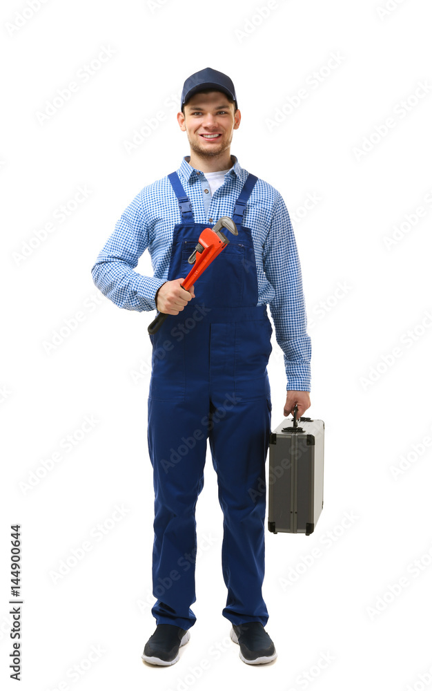 Wall mural Young plumber holding pipe wrench isolated on white