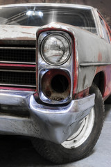 Headlight of old retro car with rust on bodywork, recovery of vintage automobile, selective focus 