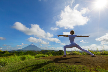 Serenity and yoga practicing,meditation at Quitinday hills location,Mayon volcano at background, Philippines