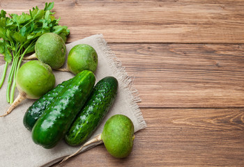 Green vegetables and salad on a wooden background. Top view with space for text