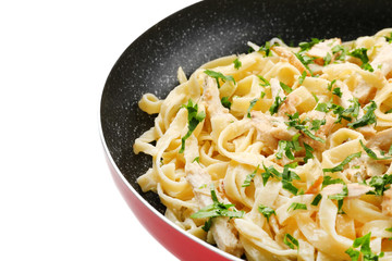 Frying pan with delicious chicken Alfredo on white background