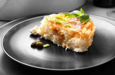 Delicious cooked chicken and rice on black plate