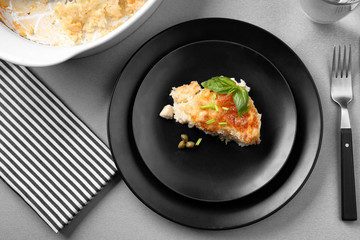 Delicious cooked chicken and rice on black plate