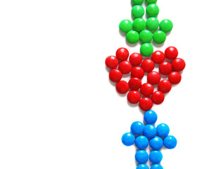 Heart and arrows made of delicious candies on white background