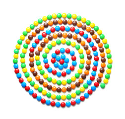 Obraz premium Swirl made of delicious candies on white background