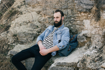 tourist man resting in the mountains while ascending to the top