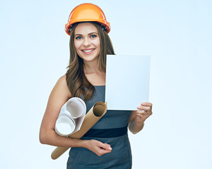 Smiling young business woman architect holding white empty advertising banner.