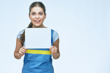smiling woman worker wearing coverall holding advertising banner.