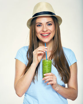 Smiling woman dressed in casual clothes and hat holding glass