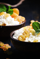 Cottage cheese with raisins, selective focus