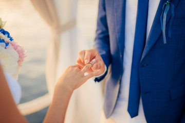 The newlyweds exchange rings at a wedding in Montenegro.