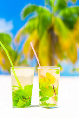Two cold tasty mohito cocktails on the white sandy beach