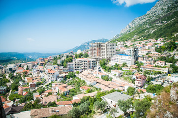 2016, Albania, Kruja. Beautiful view to the city and moutains. Blue sky and green landscape with red roofs of the city