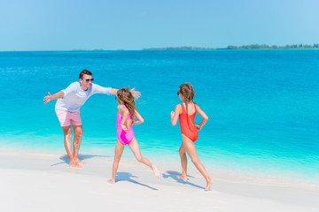 Happy family enjoying beach time and have a lot of fun