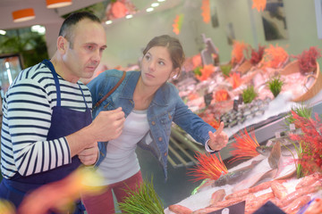 Fototapeta na wymiar Customer talking to fishmonger