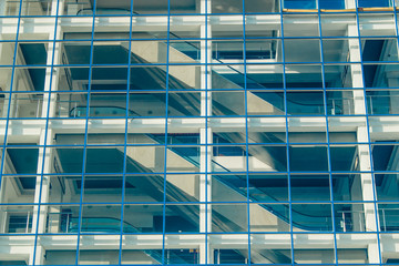 Fototapeta na wymiar Glass facade of a modern building with escalator.