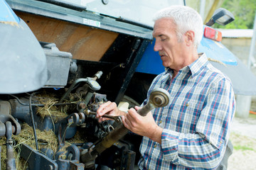 fixing an old farm machine