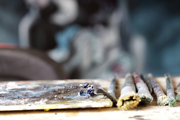 oil paints and paint brushes on a palette