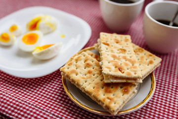 Fototapeta na wymiar Two cups of coffee, cracker, egg, breakfast