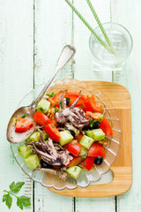 Mediterranean salad with octopus tomatoes cucumber