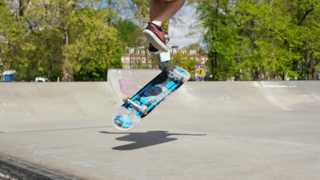 Skateboarder doing tricks on his skateboard, in slow motion 