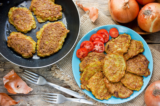Fried onion fritters served with fresh tomatoes