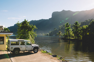 Four wheel drive by riverside and mountains, Mo'orea, South Pacific 