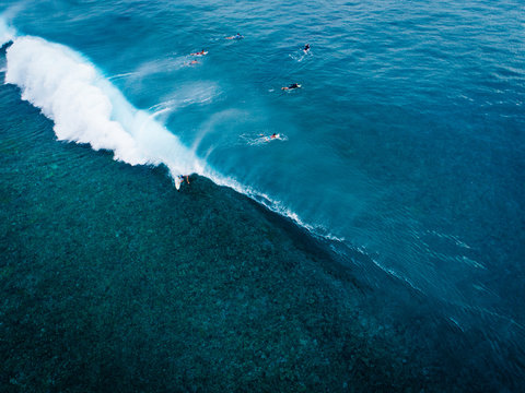 Aerial view of people paddling out to sea on surfboards, Teahupoo, Tahiti, South Pacific