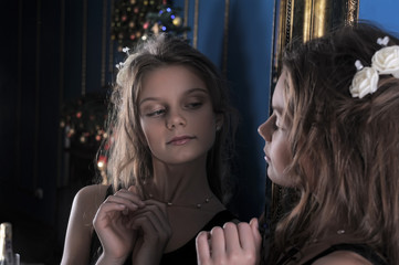 Girl admires herself in the mirror