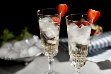 Refreshing cocktails with strawberry on gray table