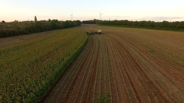Aerial video of harvesting a corn field in germany with a combine harvester
