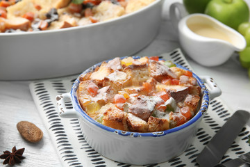 Freshly baked bread pudding in casserole dish on table