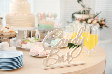 Wooden decor on table with sweets prepared for party