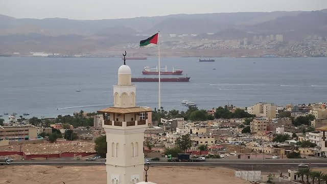 View of the Aqaba city and gulf of Aqaba in Hashemite Kingdom of Jordan and Eilat city in Israel at the distance. View from mountain in Aqaba city, Jordan. Two city and two country in one video clip