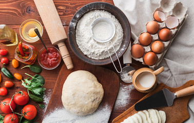 Step-by-step boss makes a pizza margarita. Dough and pizza ingredients