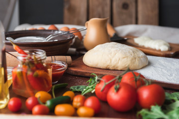 Step-by-step boss makes a pizza margarita. Dough and pizza ingredients