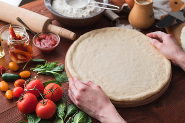 Step-by-step boss makes a pizza margarita. Dough and pizza ingredients