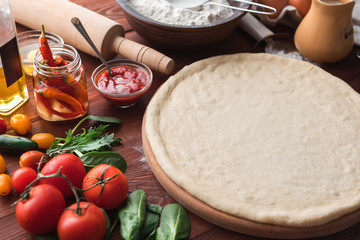 Step-by-step boss makes a pizza margarita. Dough and pizza ingredients