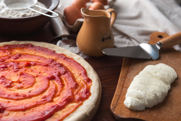 Step-by-step boss makes a pizza margarita. Dough and pizza ingredients