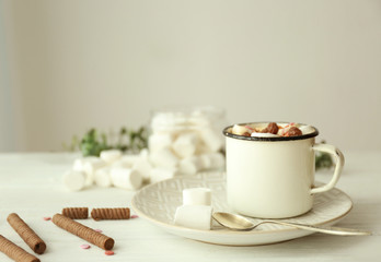 Composition with tasty cocoa and marshmallow on wooden table